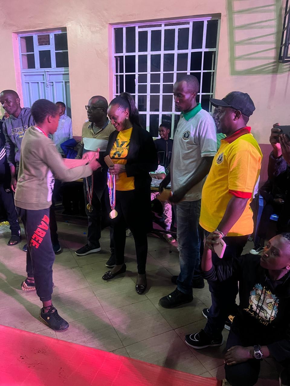 A young person receiving a certificate and medal at a youth talent and skills awards ceremony