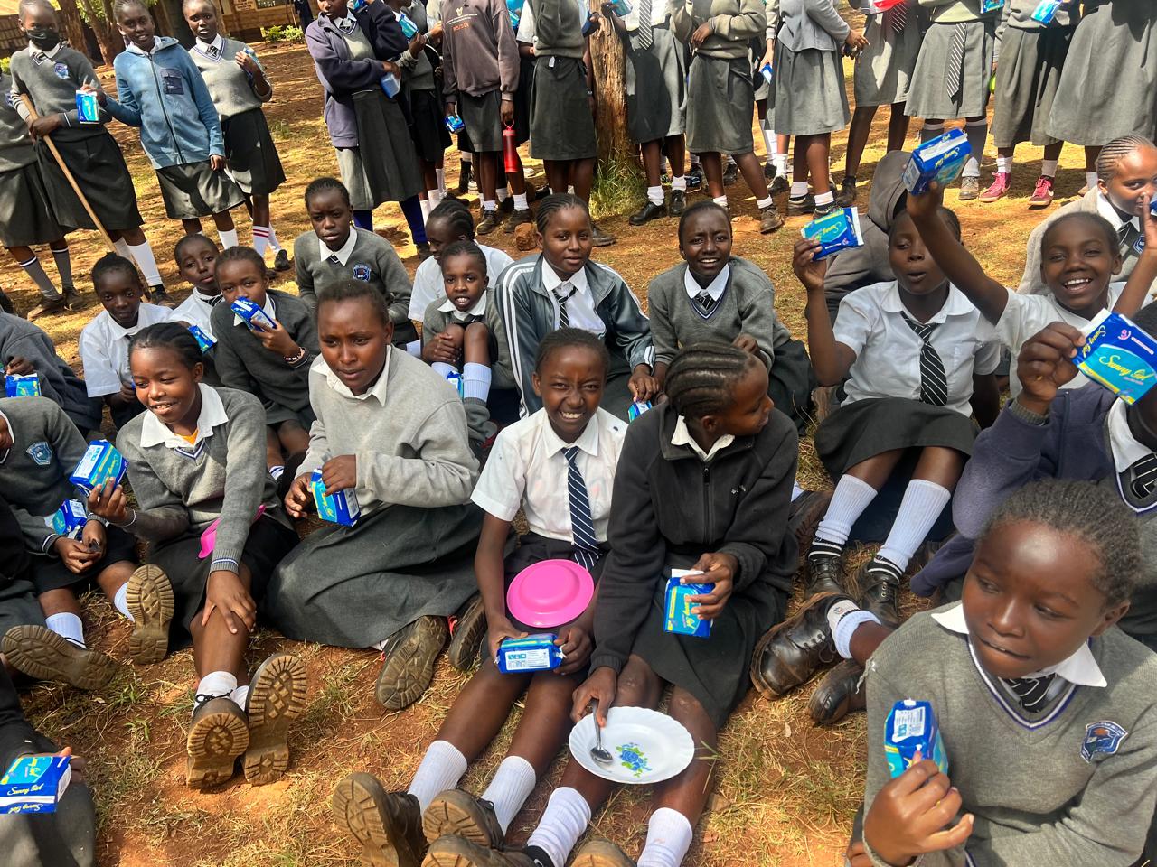 Schoolgirls receiving dignity kits during a school outreach