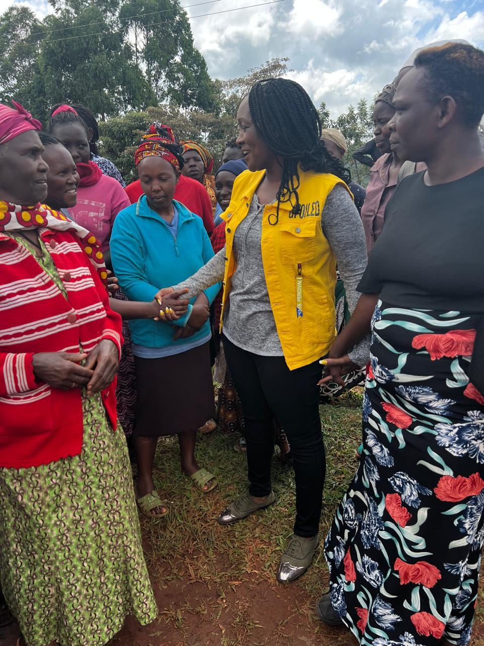 Women greeting one another during a community group meeting